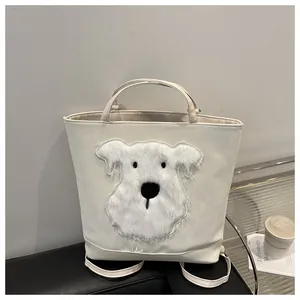 Detail of white glossy tote bag with plush puppy embroidery on minimalist studio background