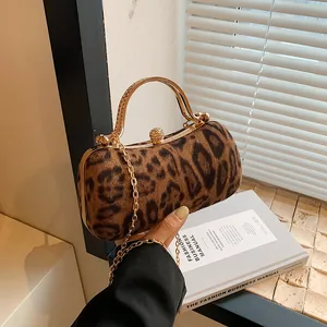Leopard print velvet clutch bag with golden metal frame and rhinestone ball clasp