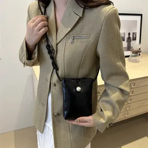 Minimalist black mini crossbody phone bag with pearl clasp and stylish woven strap