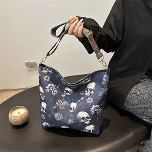 Fashionable dark blue tote bag featuring realistic skull and floral print with hobo style