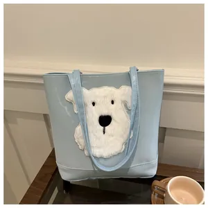 Close-up of light blue tote bag featuring a cute white plush puppy patch embroidery