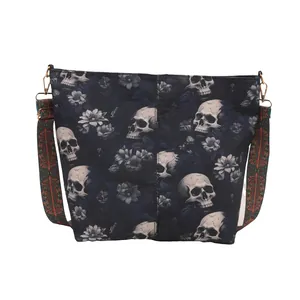Dark blue tote bag with skull and floral print featuring a wide geometric shoulder strap