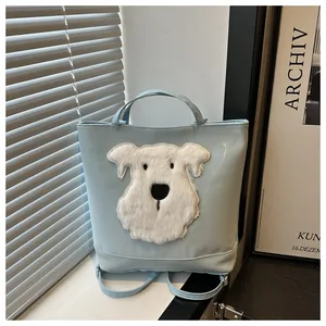 Detail of light blue tote bag featuring a plush white dog patch and embroidery texture