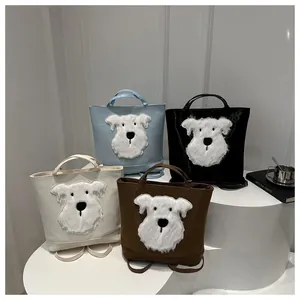 Collection of dog-themed tote bags in blue, black, white, and brown on a white display