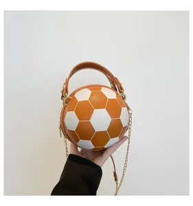 Dettaglio borsa a forma di pallone da calcio con trama litchi arancione e catena d'oro
