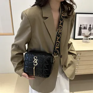 Chic black quilted crossbody bag for women with tassel and stylish patterned strap