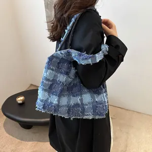 Sac bandoulière en denim matelassé avec carreaux bleus et bords effilochés