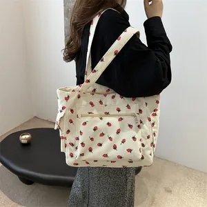 Minimalist beige corduroy tote bag with red strawberry pattern and side pockets