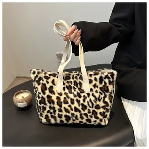 Detail of plush leopard print tote bag featuring soft faux fur texture and beige leather handles