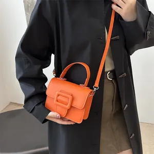 Minimalist orange crossbody handbag with a large square buckle for stylish women's fashion