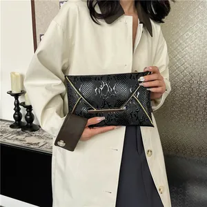 Elegant black snake pattern envelope clutch bag with gold metal trim for women