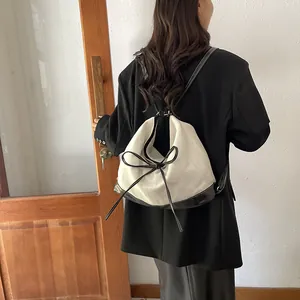 Contrast canvas tote bag with black leather trim and bow detail for commuting