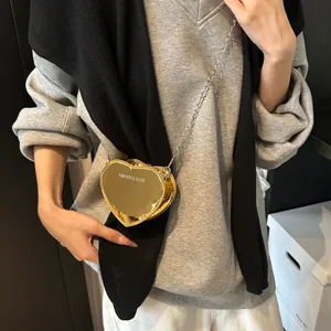 Chic heart-shaped mini crossbody bag in mirror gold finish with metallic chain strap