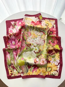 Detailed macro view of wine red silk scarf with elegant colorful floral botanical pattern