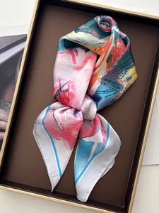 Macro detail of artistic floral oil painting print on silk scarf in a premium gift box