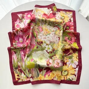 Detailed view of floral silk scarf with burgundy border and intricate botanical prints