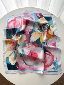 Artistic oil painting flower silk scarf detail showing vibrant floral patterns on white table