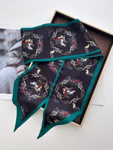 Detail of equestrian print silk scarf featuring horse chains and vibrant green edges