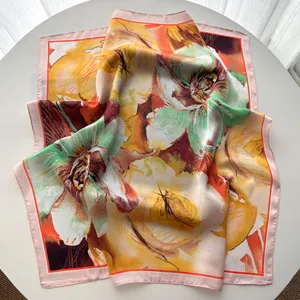 Detailed close-up of silk-like floral square scarf with oil painting floral patterns
