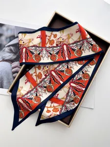 Detail of silk twilly scarf with equestrian horse print in a golden gift box