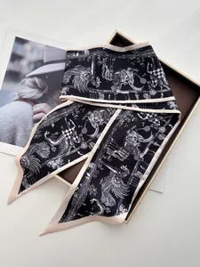 Close-up of elegant silk scarf with artistic animal prints on a brown styling tray