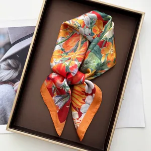 Detail of elegant floral silk scarf with tulip pattern in a premium gift box