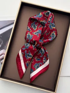 Detail of red paisley silk scarf with blue patterns on premium leather display tray