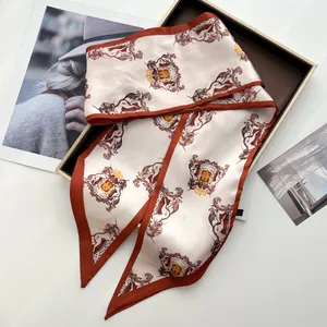 Detailed close-up of a vintage badge silk scarf on a premium gift box with fashion magazine