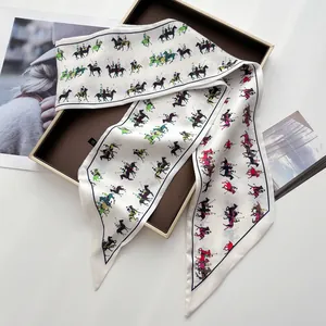 Detail of silk-like twilly scarf featuring colorful equestrian polo prints and angled ends