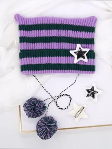 Dettaglio del berretto a strisce viola con orecchie da gatta e stelle con pompon
