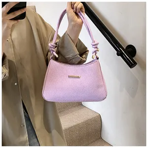 Detail of lavender chevron embossed handbag with unique braided rope knot handle
