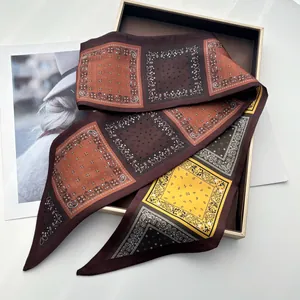 Close-up of elegant double-layered faux silk scarf with paisley patterns in a gift box
