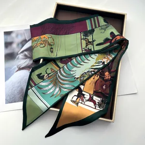 Detailed view of silk twill scarf with tropical hunter horse print in a gold gift box