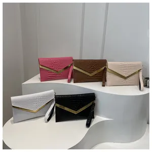 Fashionable crocodile pattern envelope clutch bags shown in five elegant colors with V-shaped metal trim