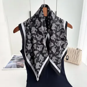 Retro paisley print silk satin square scarf styled with a luxury handbag on hanger