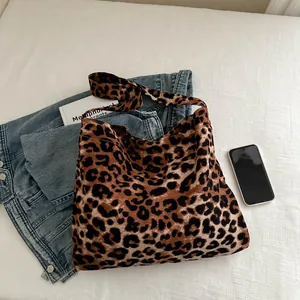 Large leopard print tote bag with wide straps on white linen for casual style