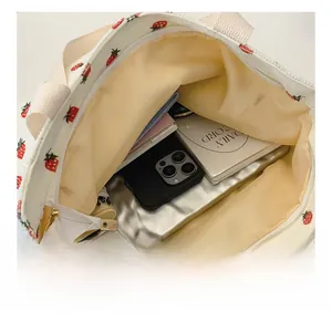 Top view showing large capacity and zipper closure of the floral strawberry tote bag