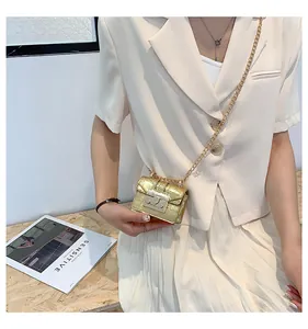 Detailed view of mini golden crocodile pattern crossbody bag with fine chain strap