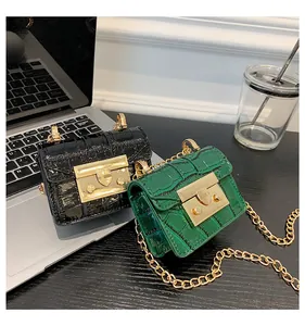 Detail of mini stone texture crossbody bags with gold chain and metal shield clasp
