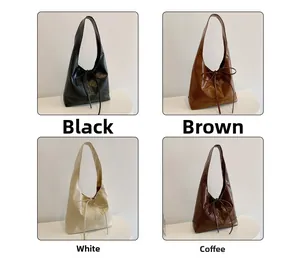 Retro leren draagtassen in zwart, bruin, crème en koffie met elegante strikdetails