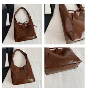 Detailweergave van de bruine vintage hobo-tas met strik en gestructureerd imitatieleer