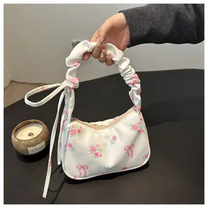 Detailopname van de bloemen canvas tas met geplooid handvat en decoratieve strik