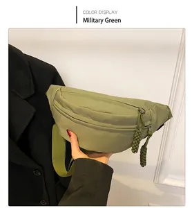 Detail of army green crescent nylon bag with woven zipper pull and adjustable strap