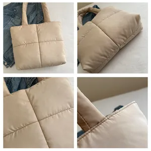 Detail view of beige quilted nylon tote bag with large square stitching and soft padding
