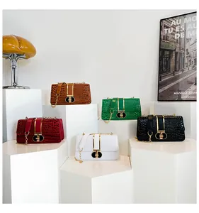 Detailed group view of colorful crocodile pattern crossbody bags with metal ring buckles