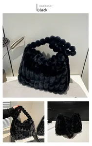 Detail of black faux fur tote bag showing plush sphere texture and soft material finish