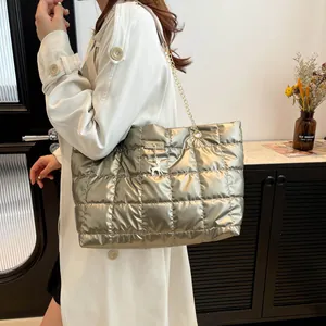 Champagne quilted tote bag with gold deer charm and chain strap shown on model