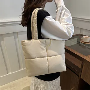 Minimalist cream quilted nylon tote bag with puffer design and soft square pattern