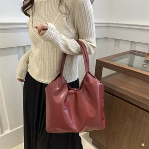 Minimalist deep red pleated cloud tote bag made of soft faux leather for daily commute wear