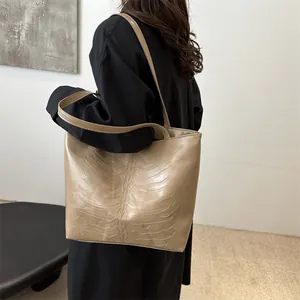 Minimalist khaki large capacity tote bag with embossed rib cage bone pattern design